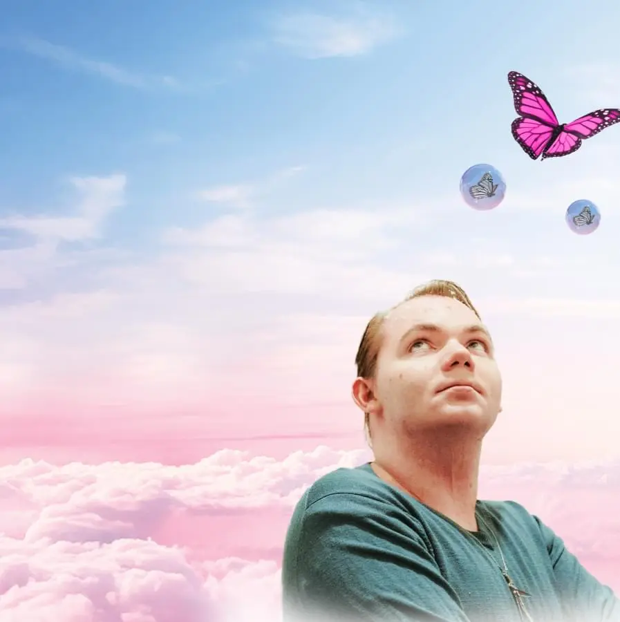Patient ambassador looking up at butterflies and bubbles
